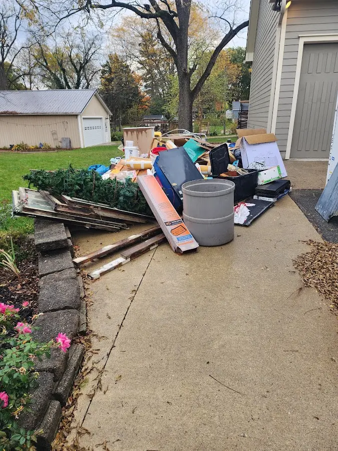Dumpster being loaded with debris for Estate Cleanout Dumpster Rental in Fairview Heights